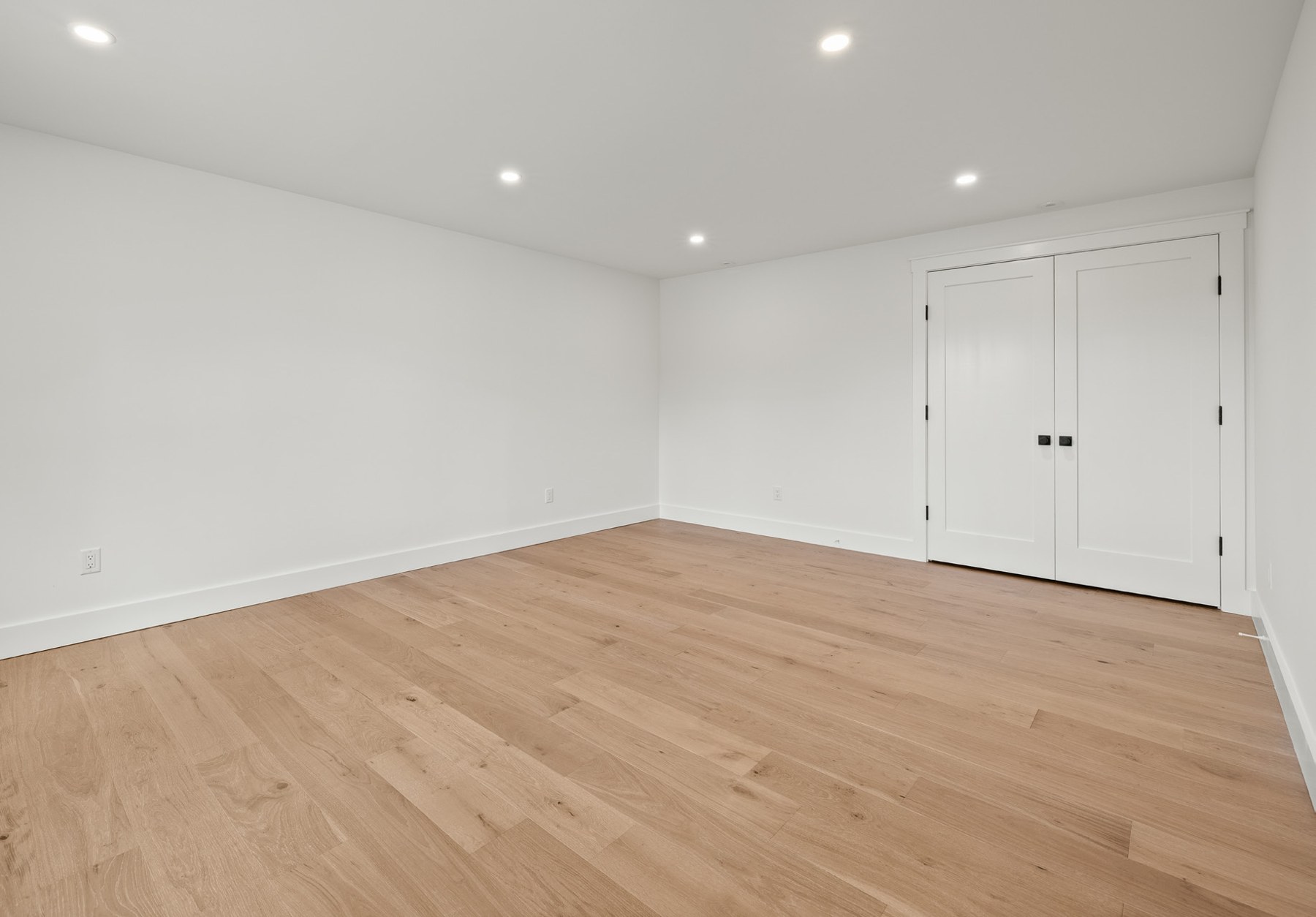 Additional bedroom with hardwood floors and double doors
