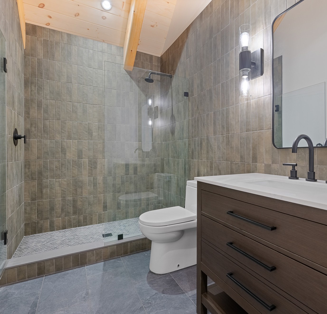 Top level bath with tiled shower and vanity