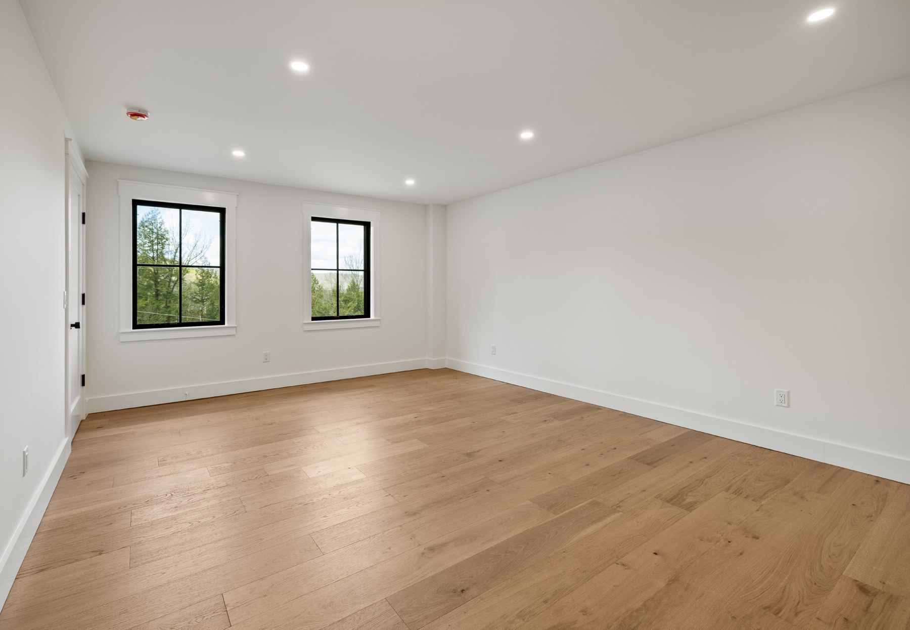 Bunkroom with hardwood floors and two windows
