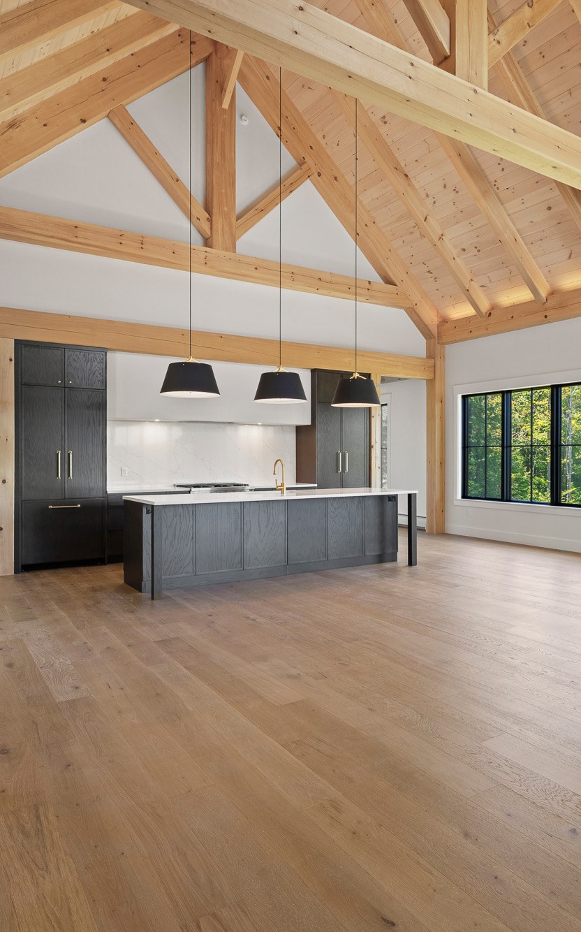 Kitchen island open to the dining area under timber beams